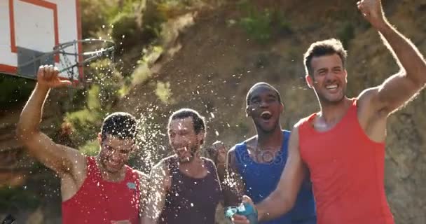 Jugadores de baloncesto celebrando por salpicaduras de agua — Vídeo de stock