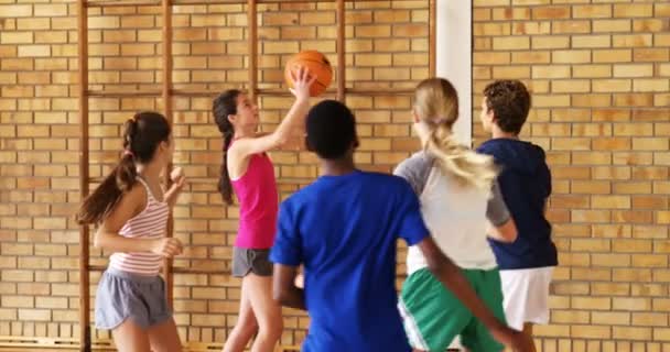 Groep van middelbare schoolkinderen spelen basketbal — Stockvideo