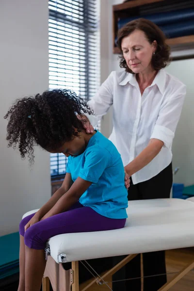 Physiotherapist giving back massage to girl — Stock Photo, Image