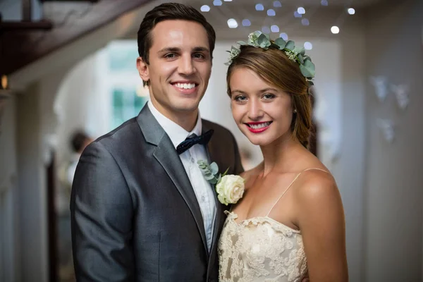 Wedding couple standing together in hall — Stock Photo, Image