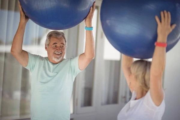 Casal sênior exercitando com bola de exercício — Fotografia de Stock