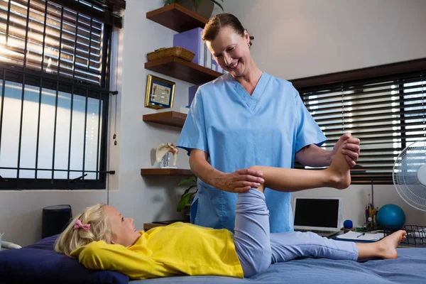 Physiotherapist giving physical therapy to girl — Stock Photo, Image