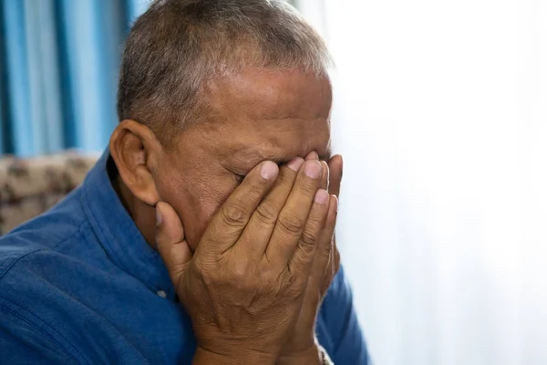 Upset senior man covering eyes with hands — Stock Photo, Image