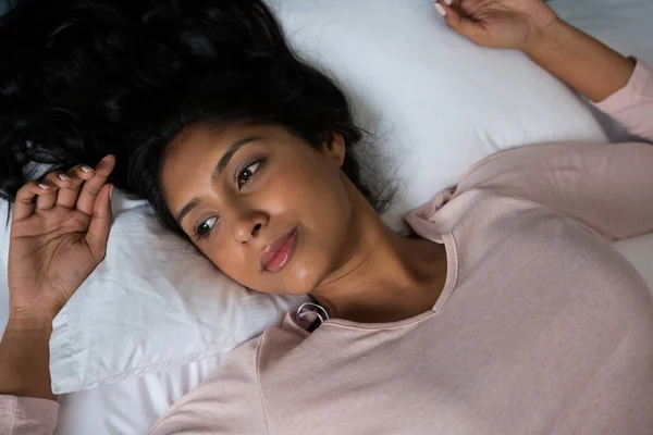 Продумана жінка розслабляється на ліжку — стокове фото