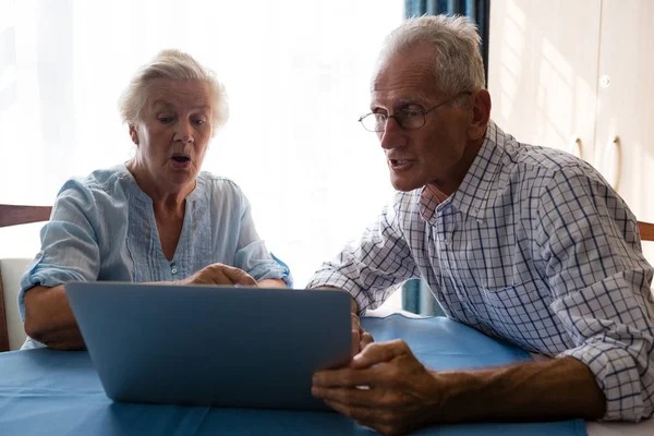 Hombre mayor mostrando portátil a mujer —  Fotos de Stock