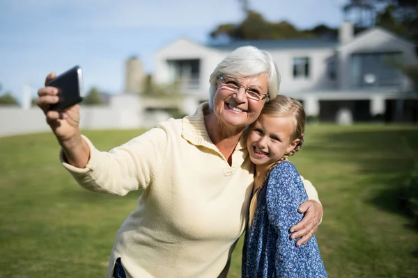 Grandmother and granddaughter taking selfie — Stock Photo, Image