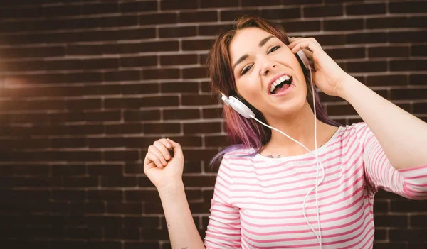 Женщина слушает музыку на наушниках — стоковое фото