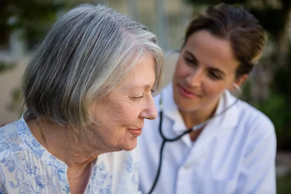 Medico donna esaminando donna anziana — Foto Stock
