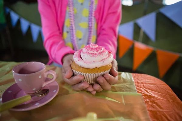 Birthday girl holding cupcake — Stock Photo, Image