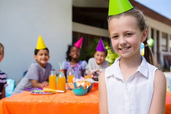 Girl with friends in background — Stock Photo, Image