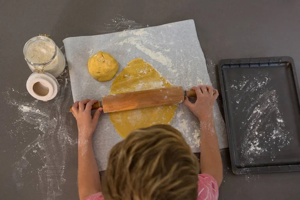 High angle view of boy rolling dough — Stock Photo, Image