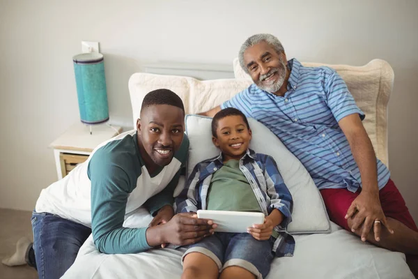 Multi generatie familie met behulp van Tablet PC op bed — Stockfoto