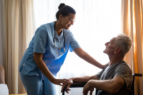 Vrouwelijke arts interactie met senior man — Stockfoto