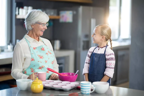 Grandmother and granddaughter looking at each other — Stock Photo, Image