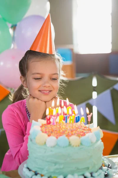 Girl looking at cake Stock Picture