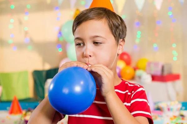 Boy blowing balloon — Stock Photo, Image