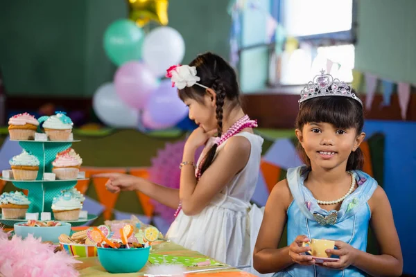 Menina bonito ter chá na mesa — Fotografia de Stock