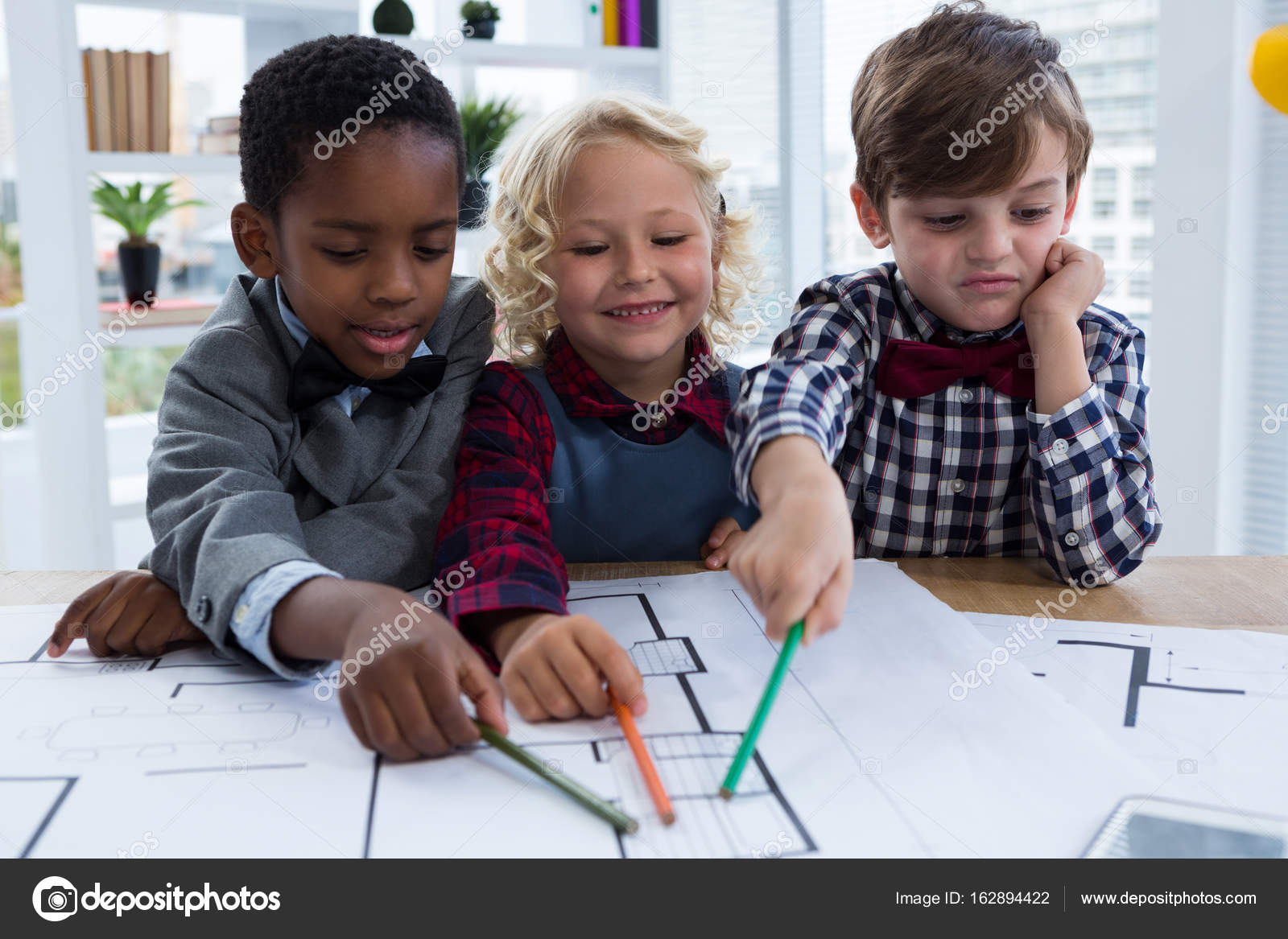 Kids analyzing blueprint Stock Photo by ©Wavebreakmedia 162894422