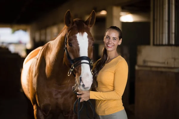 Vrouwelijke jockey permanent met paard — Stockfoto