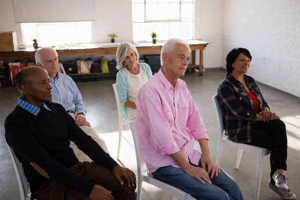 Senior people sitting on chairs — Stock Photo, Image