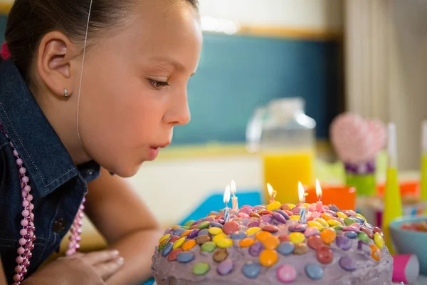 Girl blowing out candles — Stock Photo, Image