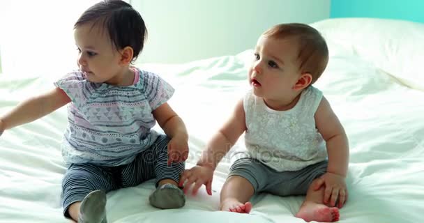 Cute baby girls sitting on bed — Stock Video