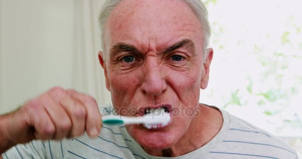 Homem sênior escovando os dentes no banheiro — Vídeo de Stock