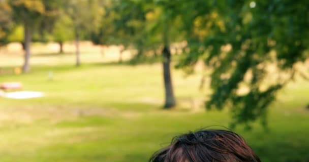 Portrait of smiling boy in park — Stock Video