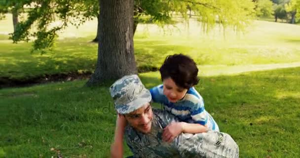 Army soldier giving piggyback ride his son — Stock Video