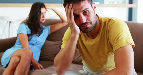 Couple ignoring each other in living room — Stock Video