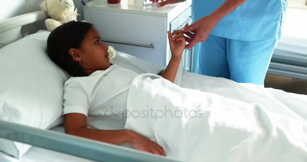 Doctor checking a sugar level of sick girl — Stock Video