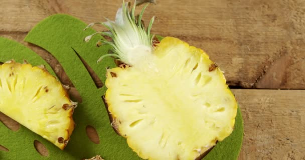 Halved pineapple on wooden table — Stock Video