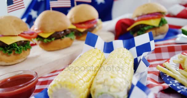 Hamburgers and french fries served on table with 4th july theme — Stock Video