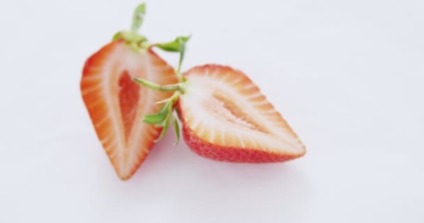 Ripe tasty strawberry cut into two halves — Stock Video