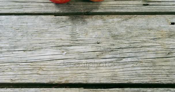 Κόκκινα μήλα τοποθετημένα σε ξύλινη σανίδα — Αρχείο Βίντεο
