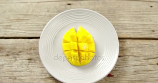 Posiekane mango w plate na drewnianym stole — Wideo stockowe