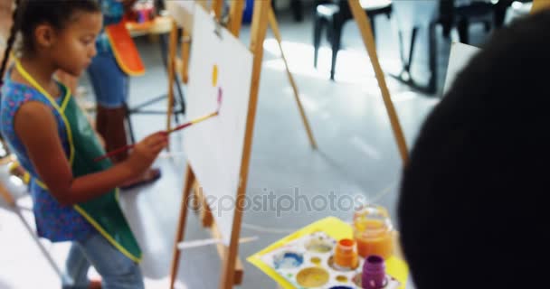 Attentive schoolboy panting on canvas — Stock Video