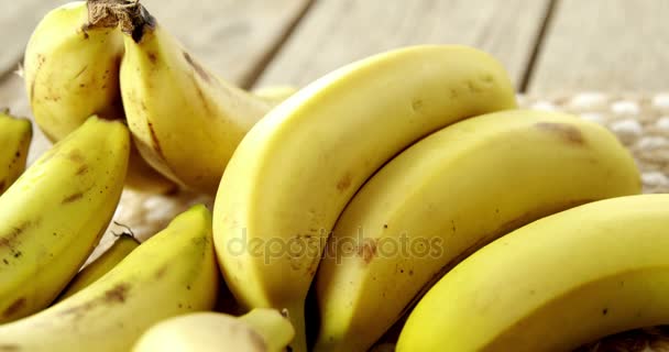 Fresh bananas on wooden plank — Stock Video