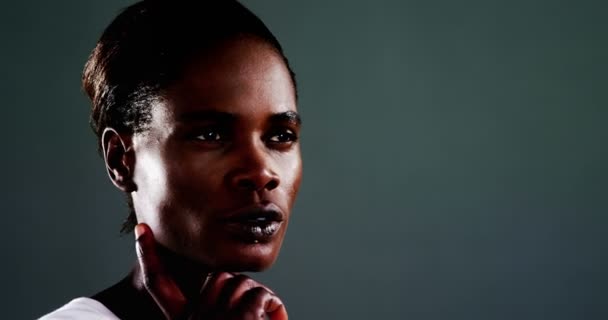 Androgynous man posing against dark background — Stock Video