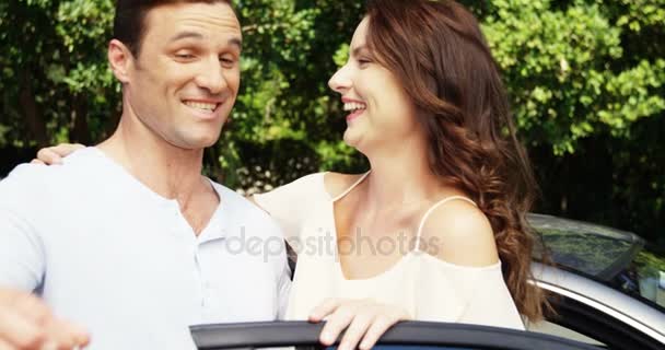 Couple interacting with each other near car — Stock Video