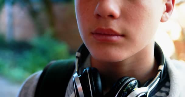 Schoolboy standing with schoolbag in campus — Stock Video