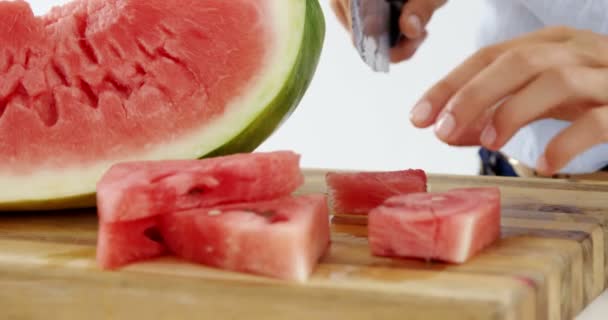 Middensectie ervan vrouw snijden vruchten op hakken bord tegen witte achtergrond — Stockvideo