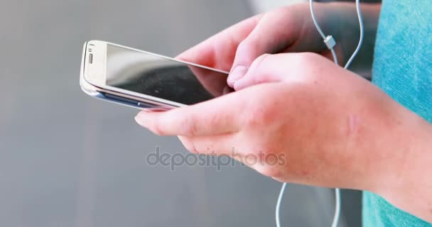 Mid-section of school kid using mobile phone — Stock Video