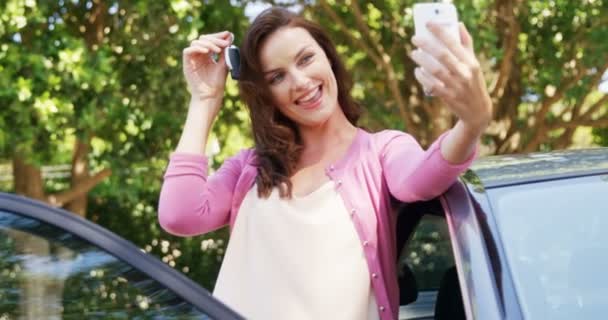 Donna che si fa un selfie sul cellulare vicino all'auto — Video Stock