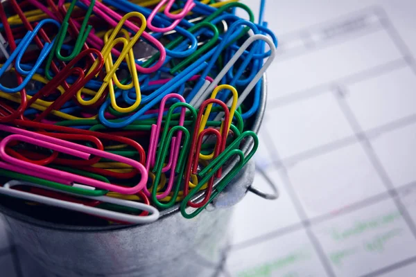 Colorful paper clips in bucket — Stock Photo, Image
