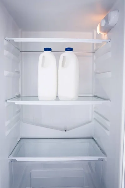 Milk bottles in refrigerator — Stock Photo, Image