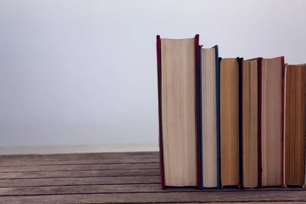 Books arranged on wooden table — Stock Photo, Image