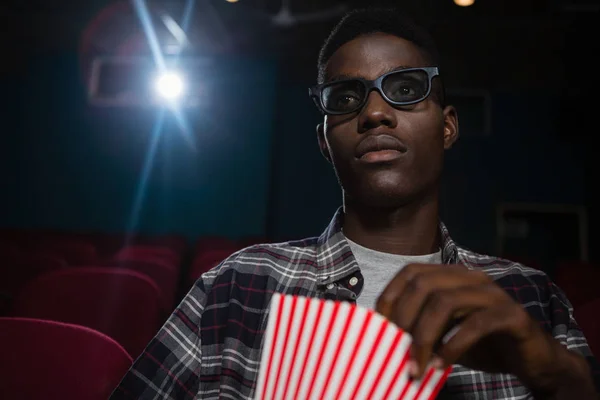 Man having popcorn while watching movie — Stock Photo, Image