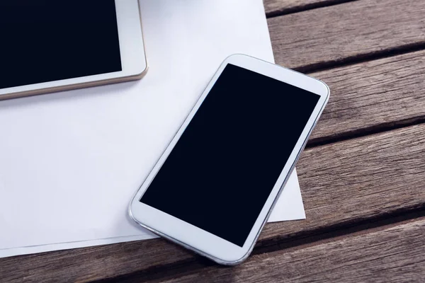 Blanco papier op tafel, Tablet en telefoon — Stockfoto