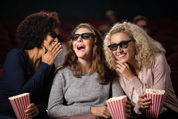 Female friends gossiping while watching movie — Stock Photo, Image